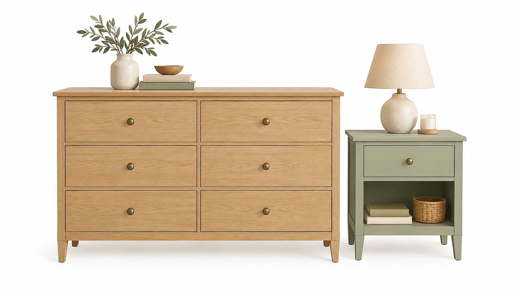 Light wood bedroom dresser beside a sage green nightstand with a lamp and decorative accents.